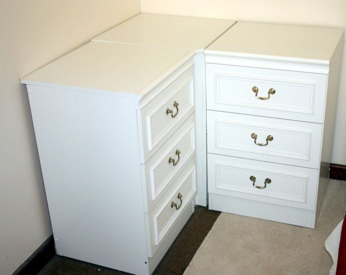 white bedroom set with a corner wardrobe